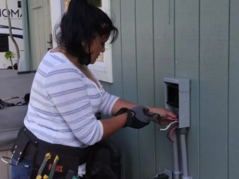 Licensed electrician wiring an exterior subpanel in Pittsboro